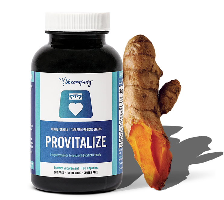 A bottle of Provitalize supplement next to a turmeric root.